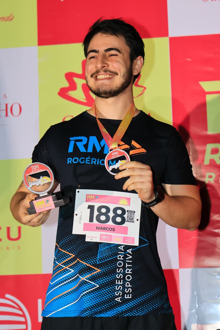 Marcos on a race podium with a trophy